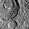 Tupo Crater, named for a Polynesian god of turmeric, is shown at upper left in this view of Ceres from NASA's Dawn spacecraft. Just below the crater, a line of narrow troughs parallels the rim of Tupo.