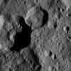Terrain seen in this view from NASA's Dawn spacecraft is in the northern hemisphere of Ceres. A sharp cliff separates Dada Crater, the smaller crater at top center, from Roskva Crater, the larger crater at left.