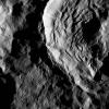 NASA's Dawn spacecraft shows Sekhet Crater on Ceres has prominent shadows accentuating its central peak and mounds of material that have slumped downward from its walls.