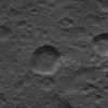 This picture from NASA's Dawn spacecraft shows craters near the equator of Ceres. Faint patches and streaks of bright material can be seen in various parts of the scene. The two largest craters have streaks of material on their walls.