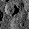 This picture from NASA's Dawn spacecraft shows a crater in the northern hemisphere of Ceres with spurs of compacted material on its walls.