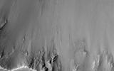 One small section of this image from NASA's Mars Reconnaissance Orbiter spacecraft shows boulders that have rolled down the slope of a crater wall. The boulders vary in size, with the largest one approximately 6 meters across.