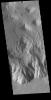 This image captured by NASA's 2001 Mars Odyssey spacecraft shows the southern wall of Juventae Chasma.
