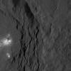 A cluster of bright areas in Ceres' Occator Crater are seen in this image from NASA's Dawn spacecraft. These areas are not as bright as the material at the center of the crater.