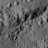 This image from NASA's Dawn spacecraft shows the edge of Ezinu Crater on Ceres. Dawn took this image on June 10, 2016, from its low-altitude mapping orbit, at a distance of about 240 miles (385 kilometers) above the surface.