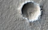 This image from NASA's Mars Reconnaissance Orbiter shows a circular impact crater and an oval volcanic caldera on the southern flank of a large volcano on Mars called Pavonis Mons.