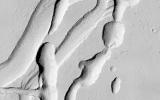 This image from NASA's Mars Reconnaissance Orbiter shows a complicated area containing various types of channels, pits and fractures near Olympica Fossae.