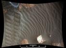 This image from an animation shows wind blowing sand underneath NASA's Curiosity Mars rover on a non-driving day for the rover.