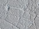 This area of Amazonis Planitia to the west of the large volcano Olympus Mons was once flooded with lava as seen by NASA's Mars Reconnaissance Orbiter. A huge eruption flowed out across the relatively flat landscape.