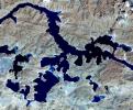 Yamzho Yumco (Sacred Swan) Lake in Tibet is surrounded by snow-capped mountains and is one of the three largest sacred lakes, as shown in this image from NASA's Terra spacecraft.