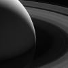 Saturn's graceful lanes of orbiting ice (its iconic rings) wind their way around the planet to pass beyond the horizon in this view from NASA's Cassini spacecraft.