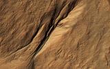 Gullies eroded into the steep inner slope of an impact crater at this location appear perfectly pristine near Gasa Crater, in this image captured by NASA's Mars Reconnaissance Orbiter (MRO).