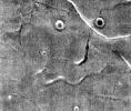This image captured by NASA's 2001 Mars Odyssey spacecraft resembles a face staring back at the spacecraft.