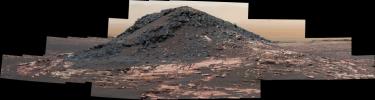 This dark mound, called 'Ireson Hill,' rises about 16 feet (5 meters) above redder layered outcrop material of the Murray formation on lower Mount Sharp, Mars, near a location where NASA's Curiosity rover examined a linear sand dune in February 2017.