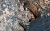 This image from NASA's Mars Reconnaissance Orbiter is of a rugged and open terrain of a stark shore-line in Meridiani Planum, giving the impression of a cloud-covered cliff edge with foamy waves crashing against it.
