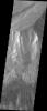 This image captured by NASA's 2001 Mars Odyssey spacecraft shows the part of the northern cliff face of Hebes Chasma at the top of the image.