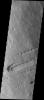 This image from NASA's 2001 Mars Odyssey spacecraft shows part of the southeastern flank of Pavonis Mons. Surface lava flows run down hill from the top left of the image to the bottom right.