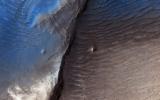 Geologists aren't quite sure what to make of the dark splotch in the middle of this image from NASA's Mars Reconnaisance Orbiter (MRO), one of several similar dark splotches that extend east and west for over 100 kilometers.