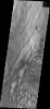 The bottom half of this image of central Candor Chasma from NASA's 2001 Mars Odyssey spacecraft shows a surface topography called chaos. Chaos is a region of small to medium sized mesas surrounded by valleys that are usually the same elevation.