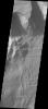 This image captured by NASA's 2001 Mars Odyssey spacecraft shows part of the central region of Tithonium Chasma. The steep wall of the canyon is visible at the top of the image.