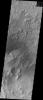 The floor of this crater contains a large exposure of rocky material, a field of dark sand dunes, and numerous patches of what is probably fine-grain sand. This image was captured by NASA's 2001 Mars Odyssey spacecraft.