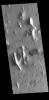 This image from NASA's 2001 Mars Odyssey spacecraft shows several features found in Lycus Sulci including tectonic derived ridges with dark slope streaks and wind etching that is eroding these materials.