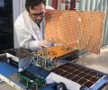 Engineer Joel Steinkraus uses sunlight to test the solar arrays on one of the Mars Cube One (MarCO) spacecraft at NASA's Jet Propulsion Laboratory.