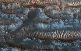 NASA's Mars Reconnaissance Orbiter shows bright ripples line the topography in this region, formed within a past climate. Dark dunes and sand streaks, composed of basaltic sand, have moved and filled lower areas, pushed by more recent winds.
