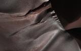 Gullies on Martian sand dunes, like these in Matara Crater, have been very active, with many flows in the last ten years. In this image from NASA's Mars Reconnaissance Orbiter frost in and around two gullies are seen.