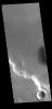 This image captured by NASA's 2001 Mars Odyssey spacecraft is located in Medusae Fossae. Along the cliffside several dark streaks are visible.