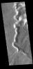This image captured by NASA's 2001 Mars Odyssey spacecraft shows one of the mega-gullies that empties into Echus Chasma. Echus Chasma is approximately 4km deep in this region, and is the source of Kasei Valles.