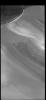 This image from NASA's 2001 Mars Odyssey spacecraft shows part of the margin of the north polar cap and the surrounding plains. The layering of the ice is easily visible due to the dust that is deposited on the top of the ice every year.