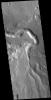 This image from NASA's Mars Odyssey shows an unnamed channel in Xanthe Terra. The large bend in the channel was created as the flow of liquid from the bottom of the image was deflected by a ridge that extends diagonally from the left center.