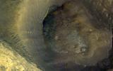This image from NASA's Mars Reconnaissance Orbiter shows a hill with a central crater. Such features have been interpreted as both mud volcanoes (really a sedimentary structure) and as actual volcanoes (the erupting lava kind).
