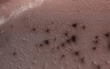 This image from NASA's Mars Reconnaissance Orbiter, acquired May 13, 2018 during winter at the South Pole of Mars, shows a carbon dioxide ice cap covering the region and as the sun returns in the spring, 'spiders' begin to emerge from the landscape.