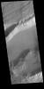 This image from NASA's Mars Odyssey shows Sirenum Fossae near Daedalia Planum. The linear breaks near the top of the cliff sides indicates surface layered materials.
