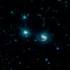 This image, by NASA's Spitzer Space Telescope, shows the merger of two galaxies, known as NGC 6786 (right) and UGC 11415 (left), also collectively called VII Zw 96.