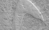 This image, acquired on April 22, 2019 by NASA's Mars Reconnaissance Orbiter, shows curious chevron shapes in southeast Hellas Planitia which are the result of a complex story of dunes, lava, and wind.
