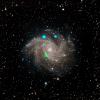 This visible-light image of the Fireworks galaxy (NGC 6946) comes from the Digital Sky Survey, and is overlaid with data from NASA's NuSTAR observatory (in blue and green).