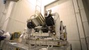 Engineers working on NASA's Mars 2020 mission remove the inner layer of protective antistatic foil from the rover after a move from JPL's Spacecraft Assembly Facility to the Simulator Building for testing.