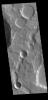 This image from NASA's Mars Odyssey shows an unnamed channel in northern Terra Cimmeria. Two impact craters occur along the length of the channel.