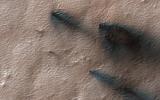 This image acquired on April 27, 2020 by NASA's Mars Reconnaissance Orbiter, shows fans of dust blown out from under the seasonal layer of carbon dioxide ice that forms a polar cap over the winter.