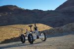 The DuAxel rover is seen here participating in field tests in the Mojave Desert. The four-wheeled rover is composed of two Axel robots. One part anchors itself in place while the other uses a tether to explore otherwise inaccessible terrain.