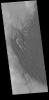 This image from NASA's Mars Odyssey shows a large sand sheet with surface dune forms, located on the complex floor of Rabe Crater.