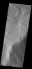 This image from NASA's Mars Odyssey shows an unusual layer of smooth material covers the flanks of the volcano Peneus Patera just south of the Hellas Basin.