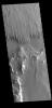 This image from NASA's Mars Odyssey shows part of Apollinaris Sulci. Yardangs are created by long term winds scouring a poor cemented surface material into linear ridges and valleys.