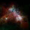 The Small Magellanic Cloud is a satellite of the Milky Way, containing about 3 billion stars. This far-infrared and radio view of it shows the cool (green) and warm (blue) dust, as well as the hydrogen gas (red).
