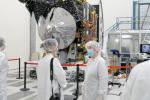 A member of the media interviews Lindy Elkins-Tanton, the principal investigator of NASA's Psyche mission, in front of the spacecraft on April 11, 2022, inside a clean room at JPL.