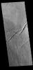 This image from NASA's Mars Odyssey shows volcanic flows and fractures between Arsia Mons and Pavonis Mons in the Tharsis volcanic region.
