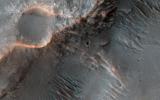 This image acquired on June 8, 2022 by NASA's Mars Reconnaissance Orbiter shows channels cutting through the ancient rim of Savich Crater.